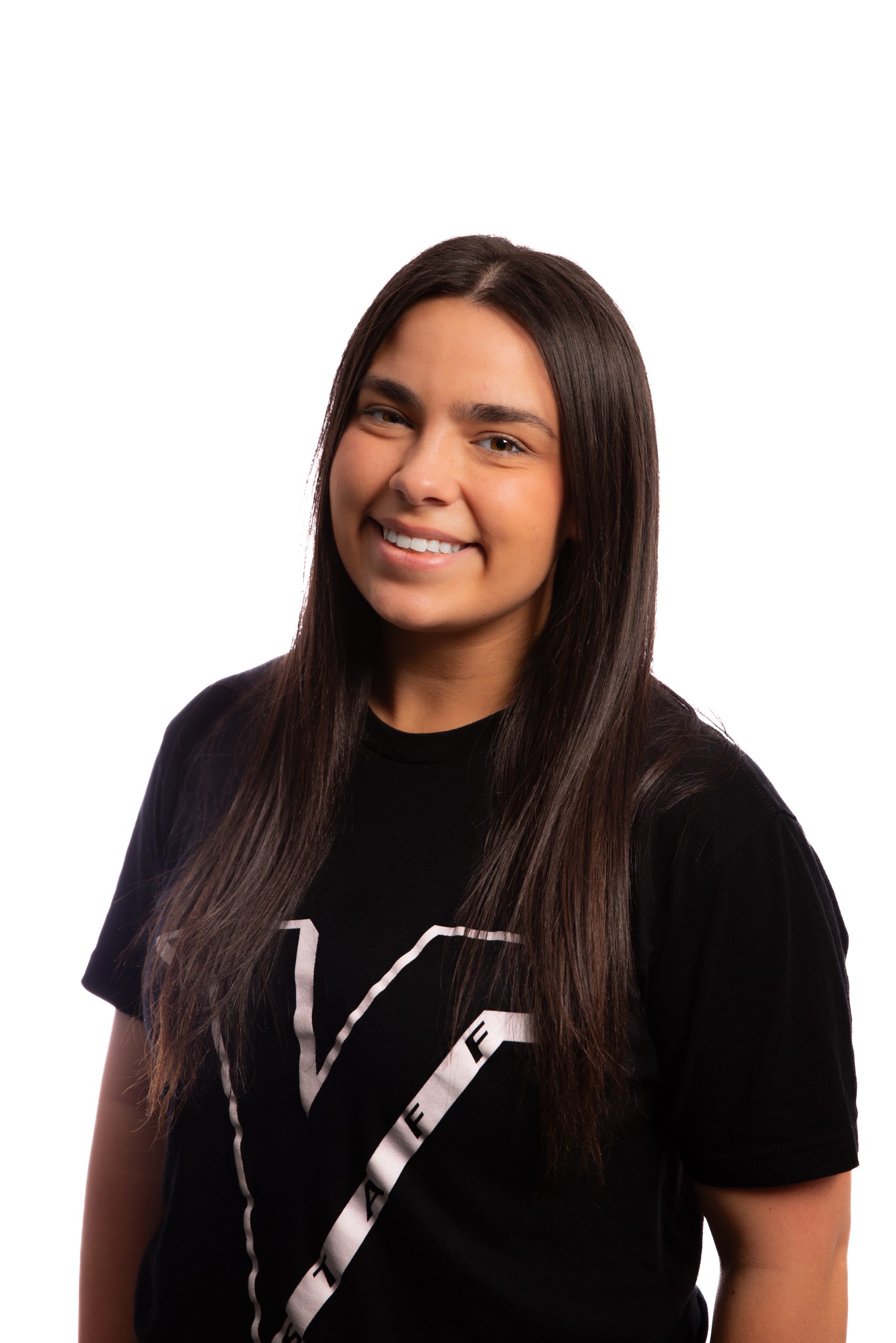 Young woman with long dark hair smiling at the camera, wearing a black T-shirt against a white background.